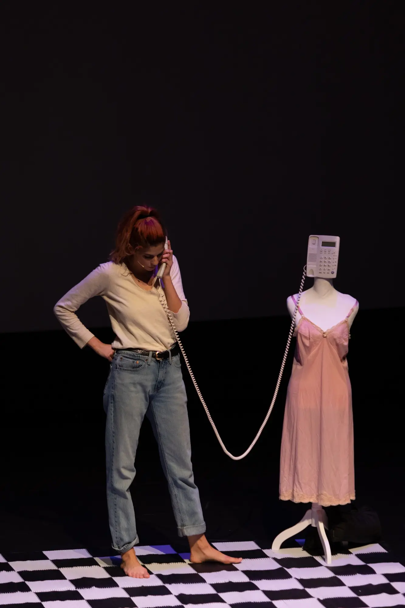A woman stands beside a dressmaker's mannequin