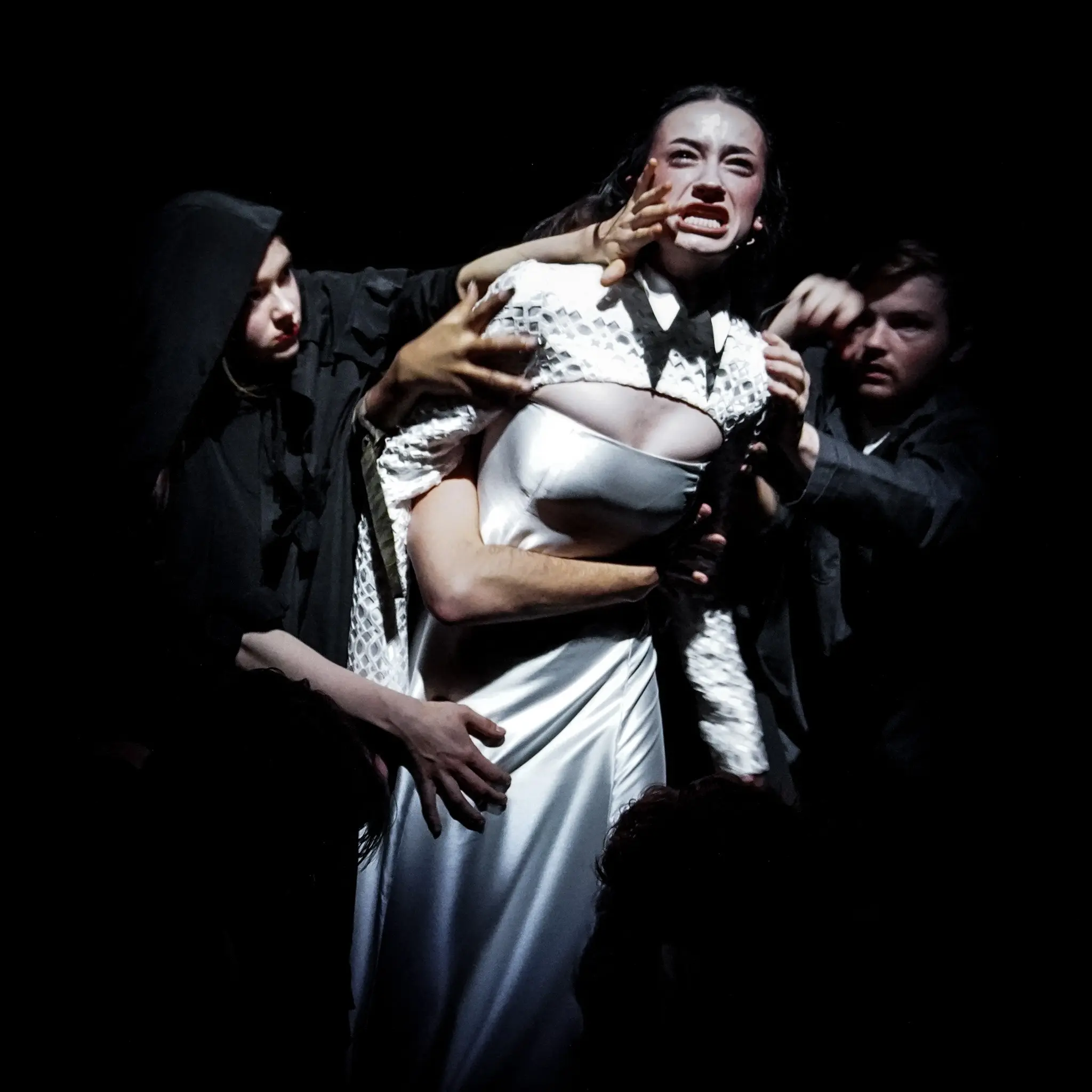 Performers form a sculptural composition