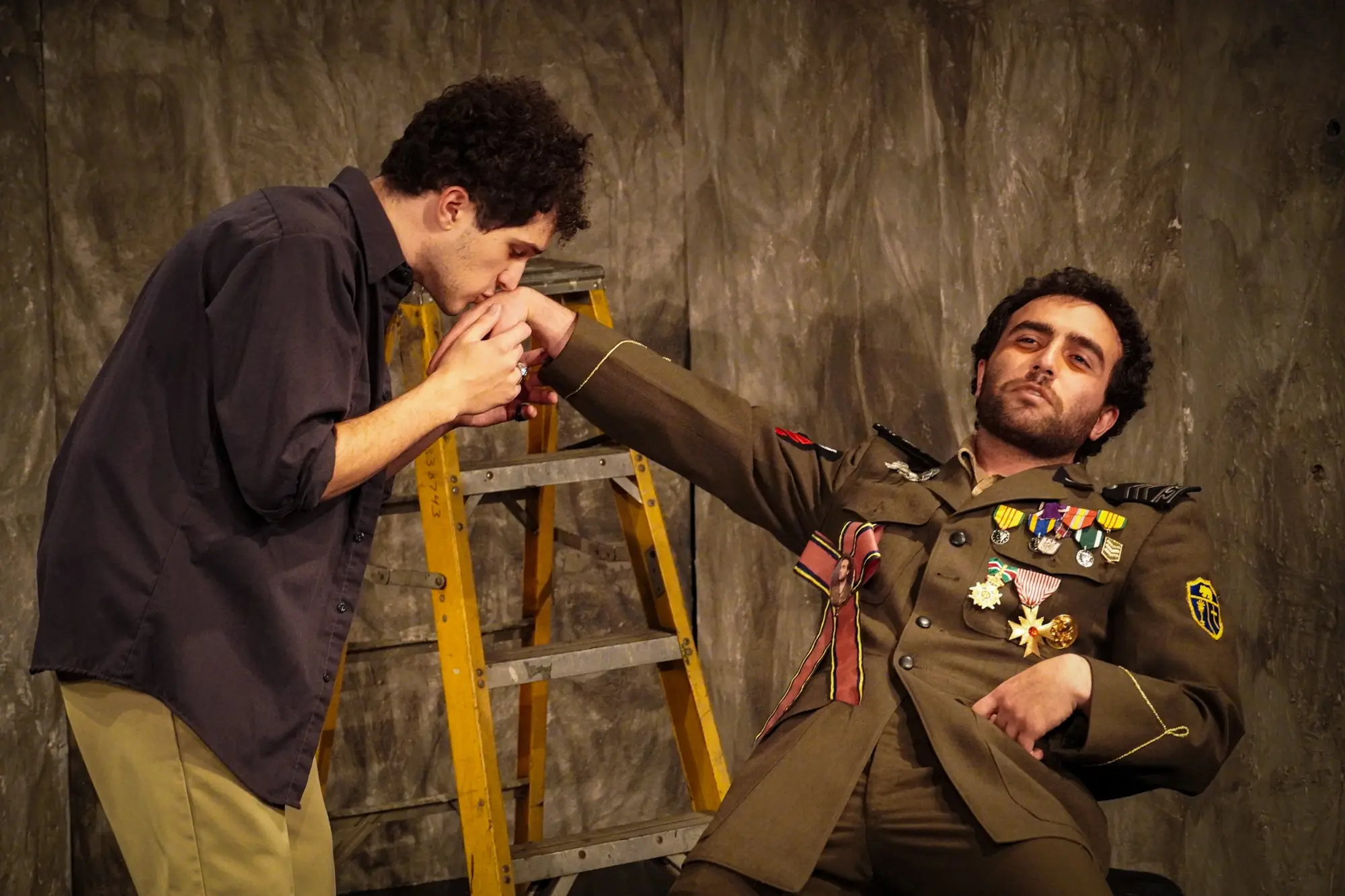 The servant grips the general's hand