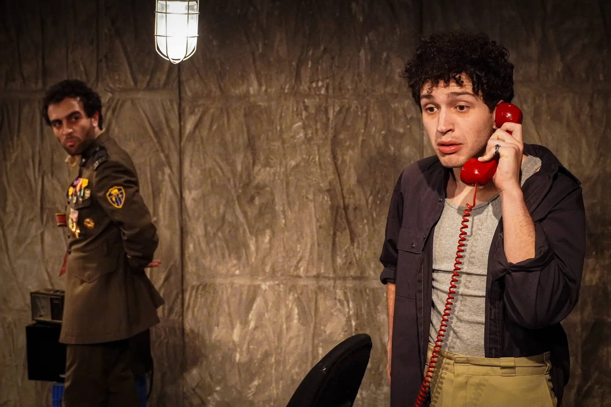 The servant speaks on a red telephone