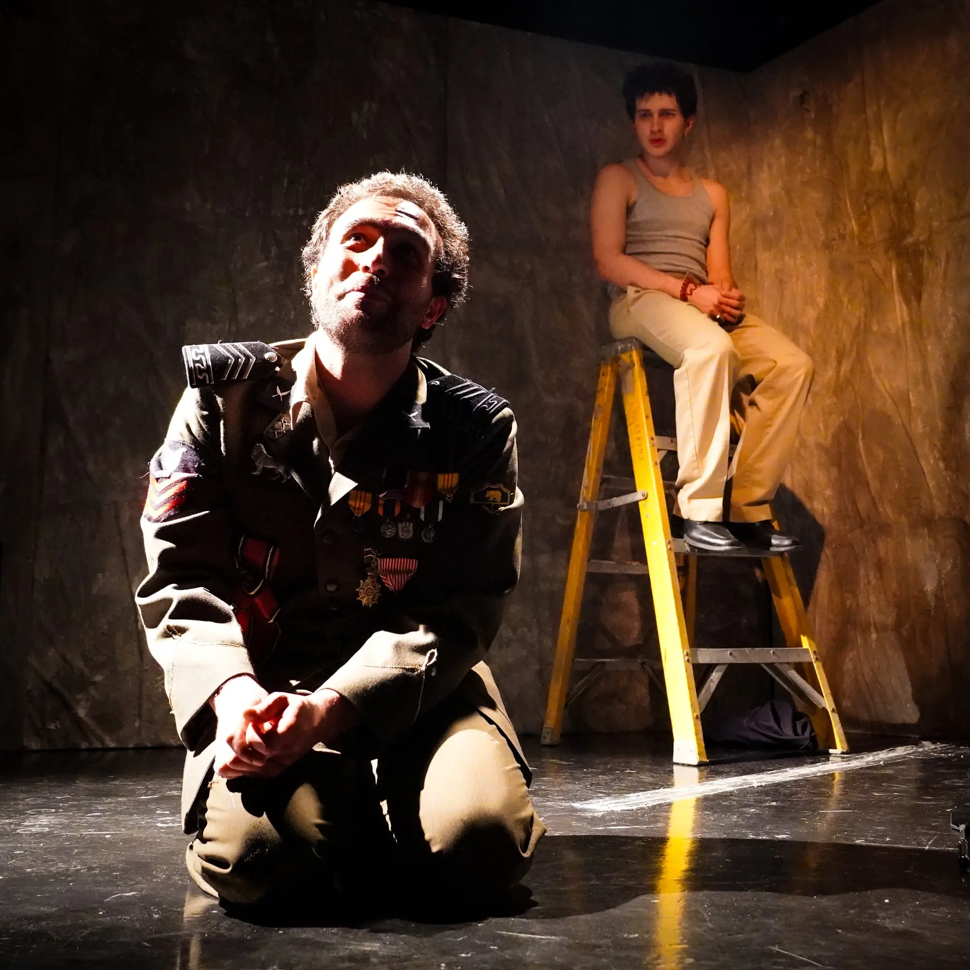 The general kneels beneath a hard light while the servant watches