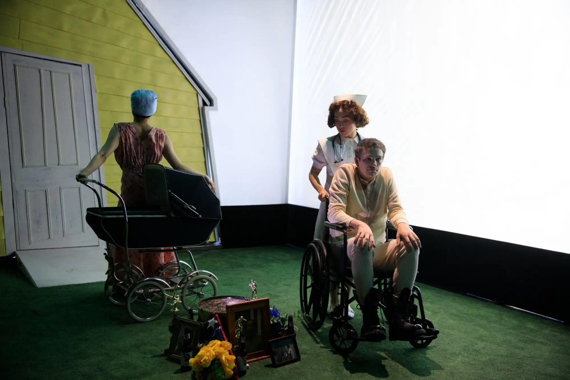 A family sits before a yellow house