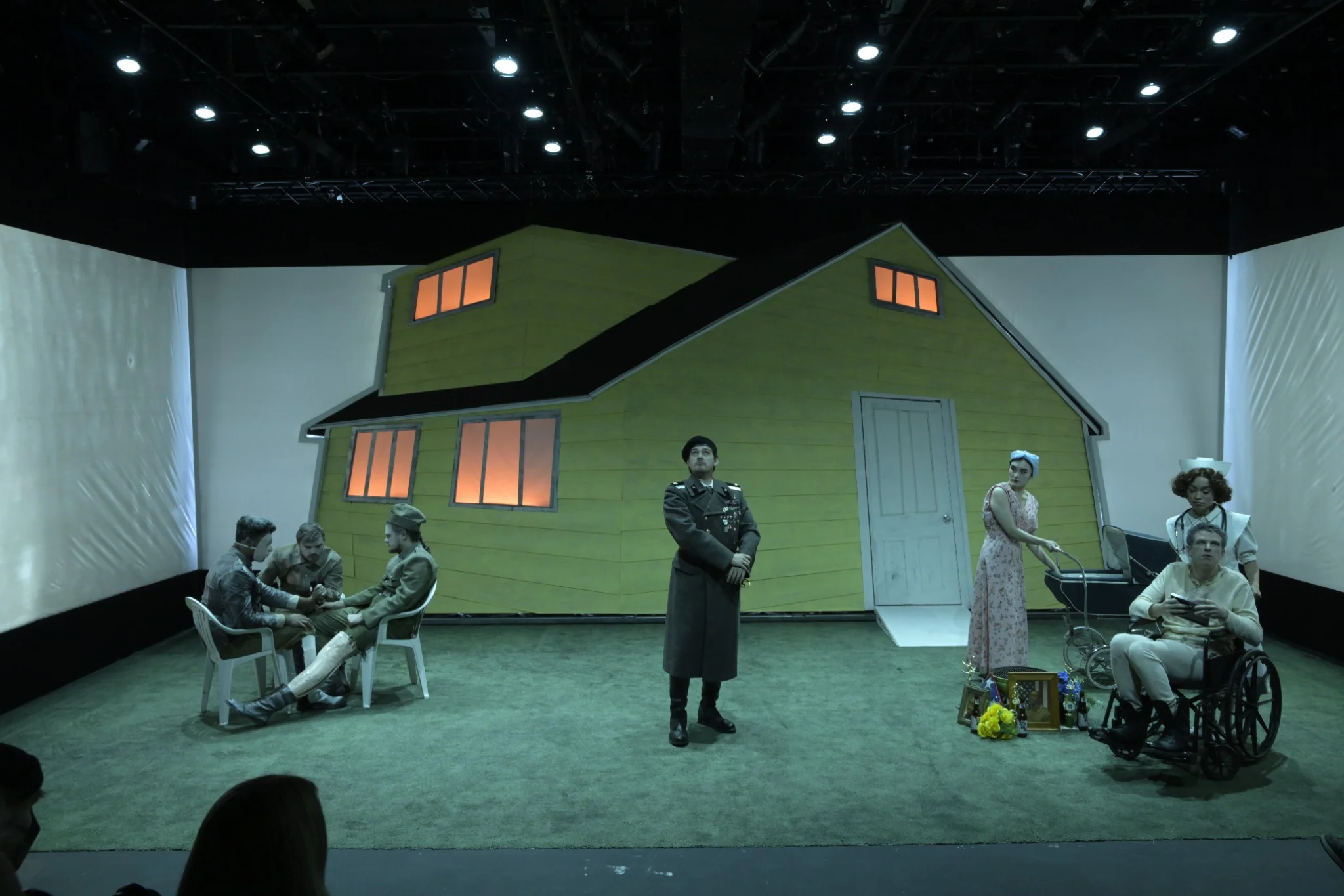 The company fills the stage around the yellow house
