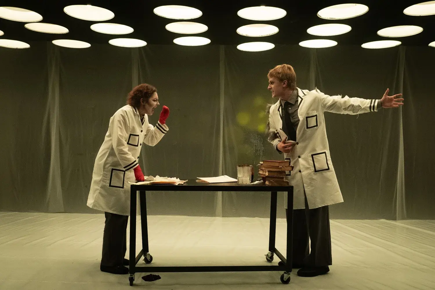 The laboratory is transformed by an intense red projection